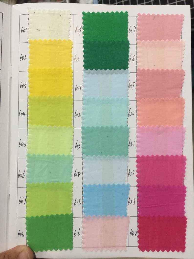 May include: A color chart with 3 columns of fabric swatches. The first column is yellow, green, and light green. The second column is light blue, blue, and pink. The third column is pink, red, and dark red. The swatches are numbered 601-624.