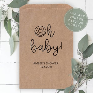 May include: A brown paper bag with a donut and the text "oh baby!" printed on it. The bag also includes the text "Amber's Shower 11.28.2021" and "Add any custom text or quote!"