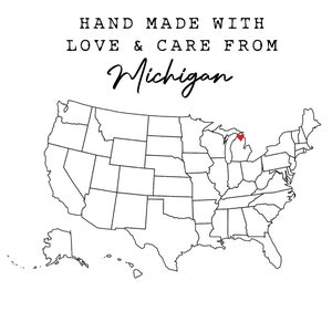 May include: A black and white outline map of the United States with a red heart over Michigan. The text "HAND MADE WITH LOVE & CARE FROM Michigan" is above the map. The text "VINTAGELEE CRAFTED" is below the map.
