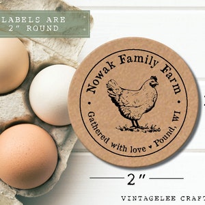 May include: A round, 2-inch kraft paper label with a black illustration of a hen and the text "Nowak Family Farm, WI." The label also includes the text "Gathered with love." Several brown and white eggs are in a cardboard carton.