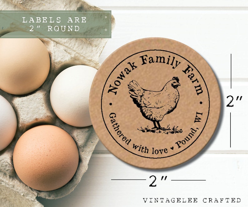 May include: A round, 2-inch kraft paper label with a black illustration of a hen and the text "Nowak Family Farm, WI." The label also includes the text "Gathered with love." Several brown and white eggs are in a cardboard carton.