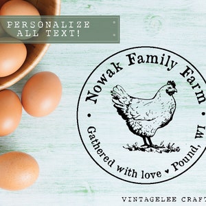 May include: A wooden bowl filled with brown eggs sits next to a circular stamp. The stamp features a hen illustration and the text "Nowak Family Farm, Gathered with love, Pound, WI". The text "Personalize All Text!" is also visible.