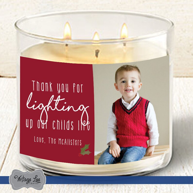 May include: A red and white candle with a photo of a young boy and the text "Thank you for lighting up our child's life. Love, The McAlister's"