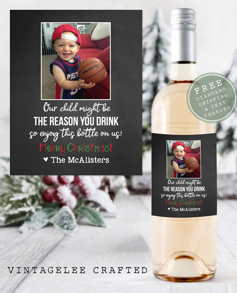 May include: A printable wine bottle label with a chalkboard background. The label features a photo of a young child holding a basketball. The text on the label reads "Our child might be THE REASON YOU DRINK so enjoy this bottle on us! Merry Christmas! &hearts; The McAlisters".
