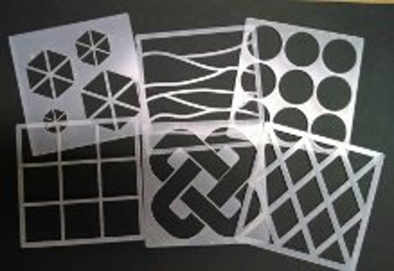 May include: Set of six white plastic stencils with various geometric designs, including circles, squares, diamonds, waves, and a knot pattern.