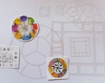 May include: A set of clear plastic stencils for painting, featuring a variety of shapes, including circles, squares, and a grid. The stencils are arranged on a white surface, with a few colorful painted circles nearby.