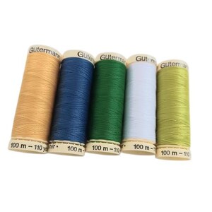 May include: Five spools of Gutermann polyester sewing thread arranged in a row. The colors from left to right are tan, navy blue, forest green, light blue, and lime green. Each spool is labeled with the brand name and 100 m - 110 yards.