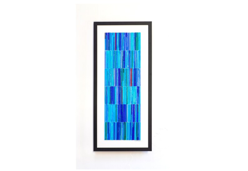 May include: Abstract art print in a black frame. The print features a pattern of vertical blue, turquoise, and green lines arranged in a grid.