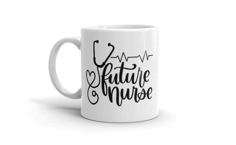 May include: White ceramic coffee mug with a black design of a stethoscope, a heart, and the text "future nurse" with a heartbeat line.