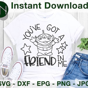 May include: A white t-shirt with a black and white graphic of a cartoon alien with the text "You've Got A Friend In Me" on it.