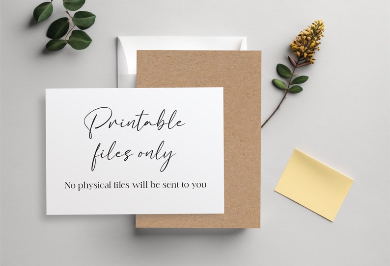 May include: A stationery set featuring a white card with the text "Printable files only" and a kraft paper card. A white envelope and a yellow sticky note are also present. Green leaves and a yellow flower add a natural touch.