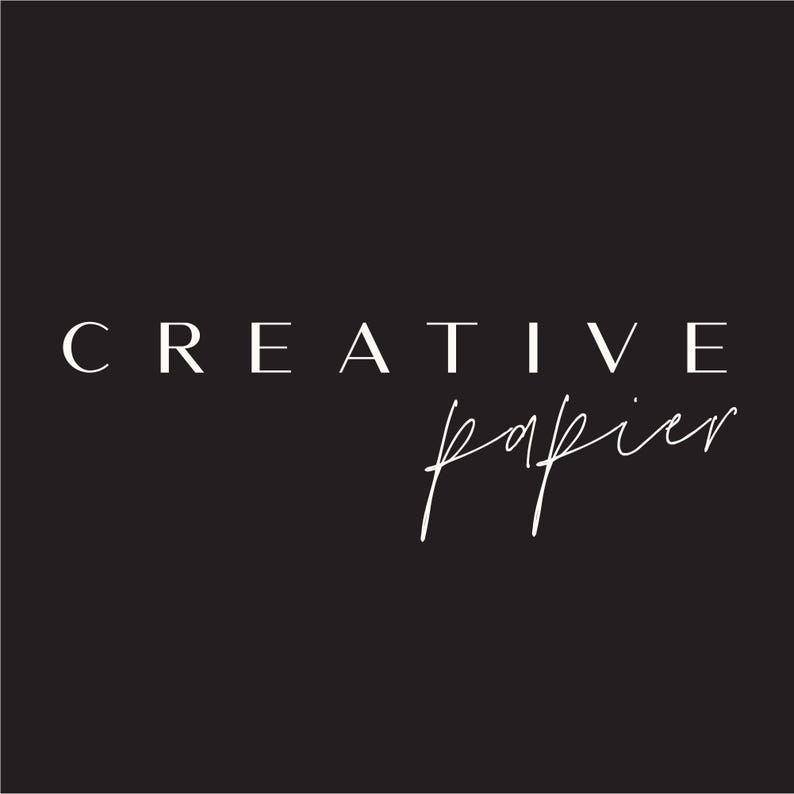 May include: Black background with the words "CREATIVE" in a serif font and "papier" in a cursive script, both in white. The design is simple and elegant, suitable for branding or stationery.