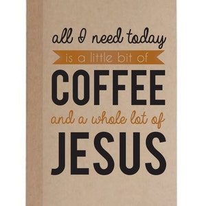 May include: A tan-colored notebook with the text "all I need today is a little bit of COFFEE and a whole lot of JESUS" in black and orange lettering. The notebook has a simple, minimalist design.