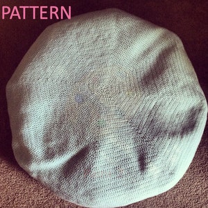 May include: A light blue crocheted cushion with a hexagonal pattern.