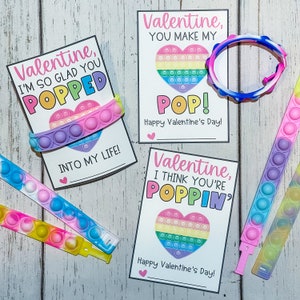 May include: Three printable Valentine's Day cards with a pop-it heart design and the text "Valentine, I'm so glad you popped", "Valentine, you make my pop!" and "Valentine, I think you're poppin'"