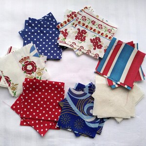May include: Assortment of fabric squares in red, white, and blue with various patterns, including polka dots, stripes, and floral designs.