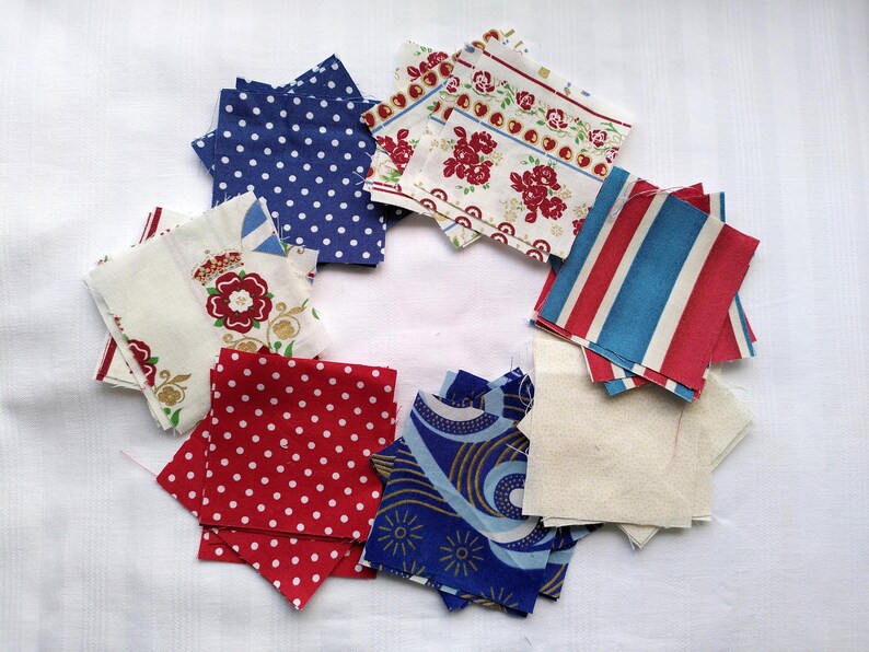 May include: Assortment of fabric squares in red, white, and blue with various patterns, including polka dots, stripes, and floral designs.
