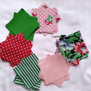 May include: A collection of fabric squares in various patterns and colors, including green, pink, red, and floral. The squares are arranged in a circle on a white surface.