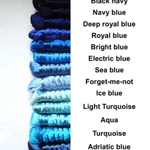 May include: A collection of 14 spools of thread in various shades of blue, from black navy to Adriatic blue. The spools are arranged vertically from darkest to lightest.