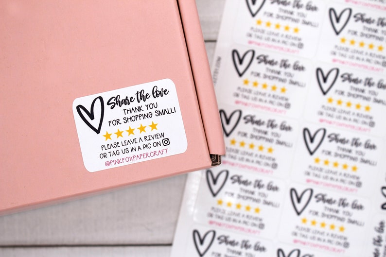 May include: White sticker with black text that reads "Share the love Thank you for shopping small!" with a black heart and five gold stars. The text also reads "Please leave a review or tag us in a pic on @pinkfoxpapercraft".