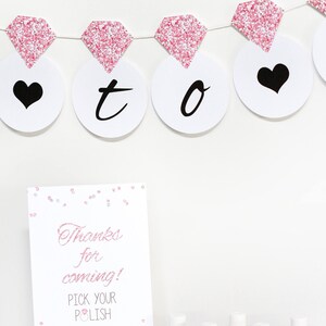 May include: A pink and white sign with the text "Thanks for coming! Pick your polish" and a pink diamond graphic.  There are six small bottles of nail polish with pink and white labels that say "Mom Thanks from the Bride".