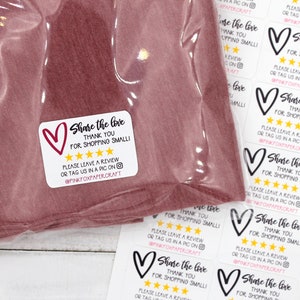 May include: White sticker with black text that reads "Share the love, thank you for shopping small!" with a black heart and five gold stars. The text also includes "Please leave a review or tag us in a pic on @pinkfoxpapercraft".