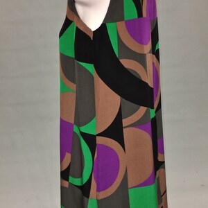 May include: A sleeveless dress with a geometric pattern in shades of black, brown, green, and purple.