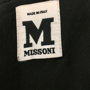 May include: White label with black text that reads "Made in Italy" and "Missoni" with a large black "M" in between the text.