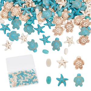 May include: A plastic container filled with blue and white sea turtle and starfish beads. The beads are scattered on a white background with a few beads in the foreground.