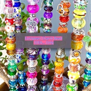 May include: Multiple vertical metal rods adorned with colorful glass and metal beads in various shapes and textures. Some beads feature floral patterns, glitter, or heart-shaped charms. A central text overlay reads: European Charm Bead IDEA... Only.
