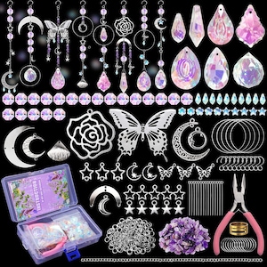 May include: A collection of craft supplies for jewelry making, including silver-toned charms, iridescent crystals, and pink tools. The assortment features butterfly, moon, and star shapes, along with a clear plastic storage box containing instructions.