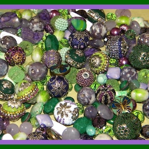 May include: A collection of beads in various shapes, sizes, and textures. The beads are primarily in shades of green, purple, and white, with some featuring intricate designs and embellishments. Some beads have a metallic sheen.