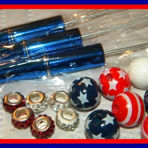 May include: Assortment of red, white, and blue star-shaped beads, along with clear crystal beads and silver spacer beads.  The beads are packaged in clear plastic bags with blue metal tubes.