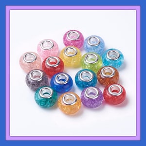 May include: Assortment of 18 colorful glass beads with silver metal accents. The beads are round and have a sparkly, glittery finish.