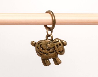 May include: A bronze-colored sheep stitch marker with a ring for attaching to knitting needles.