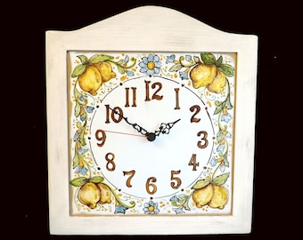 May include: White ceramic clock with a lemon and floral design. The clock face has black hands and Roman numerals.