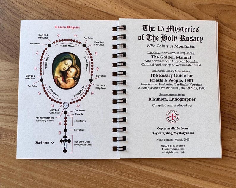 May include: Open booklet with a diagram of a rosary and text titled "The 15 Mysteries of The Holy Rosary." The diagram includes an illustration of Mary and Jesus. The booklet is spiral-bound and printed in black and red ink.