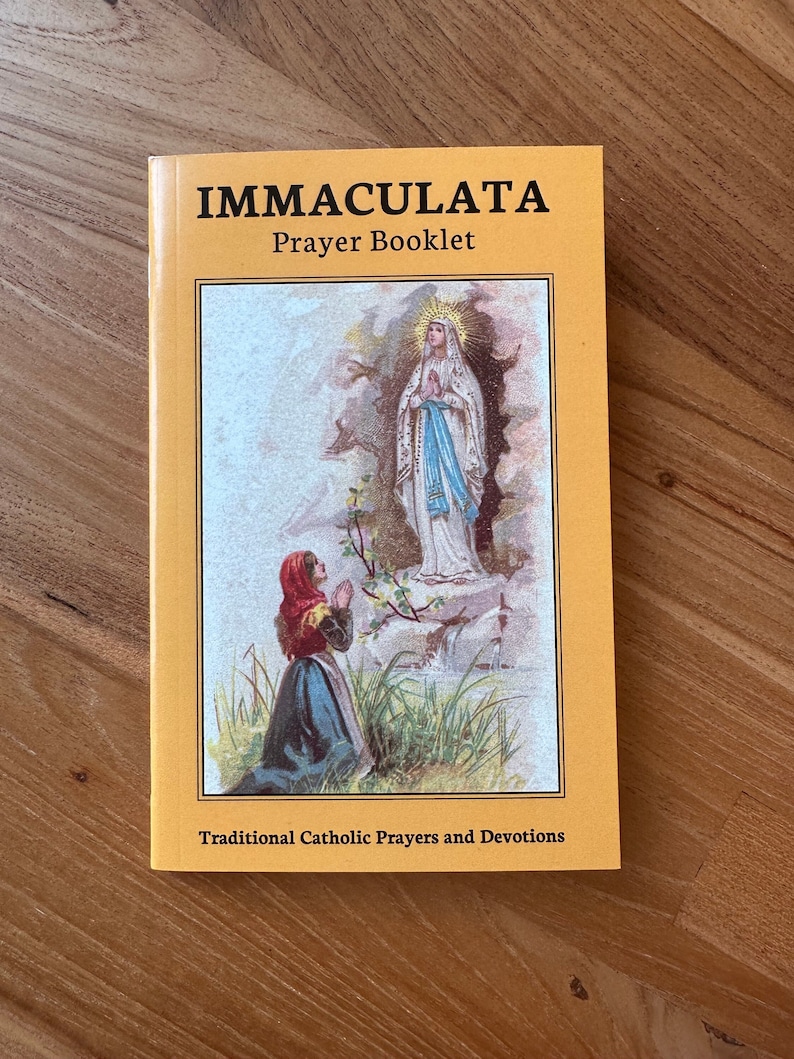 May include: A yellow prayer booklet titled IMMACULATA Prayer Booklet with the subtitle Traditional Catholic Prayers and Devotions. The cover features a color illustration of a person kneeling in prayer before a vision of the Virgin Mary.
