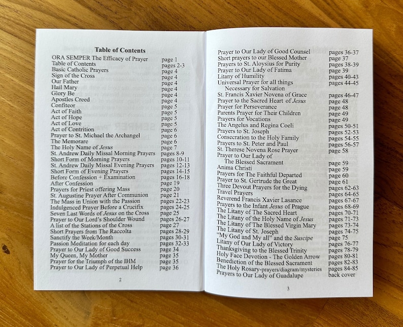 May include: An open prayer book displaying a table of contents on pages two and three. The text lists various Catholic prayers, novenas, and litanies with their corresponding page numbers, printed in black ink on white paper with a clear, readable font.