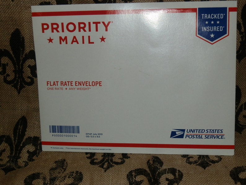 May include: White Priority Mail flat rate envelope with red and blue text and a blue star. The envelope has a red and blue "TRACKED INSURED" label with three stars. The text on the envelope reads "PRIORITY MAIL", "FLAT RATE ENVELOPE", "ONE RATE ANY WEIGHT", "PS00001000014", "EP4F July 2015", "00:12.595", "UNITED STATES POSTAL SERVICE".