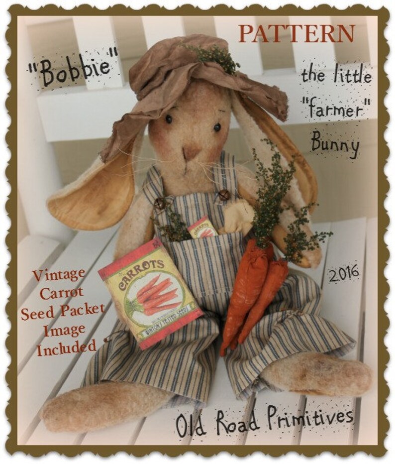 May include: A handmade bunny doll wearing overalls and a straw hat, holding a packet of carrot seeds and carrots. The doll is labeled "Bobbie" and "the little "farmer" Bunny". The image includes the text "Vintage Carrot Seed Packet Image Included" and "Old Road Primitives".