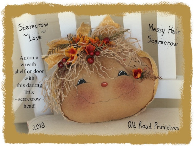 May include: A handmade scarecrow head with messy hair, a painted face, and a burlap body. The scarecrow is wearing a wreath of fall leaves and berries. The text "Scarecrow ~Love~" and "Messy Hair Scarecrow" is written on the image.
