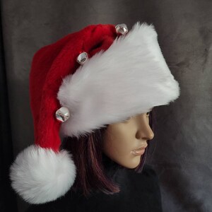 May include: A red and white Santa hat with a white fur trim and silver jingle bells.