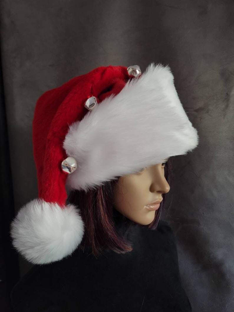 May include: A red and white Santa hat with a white fur trim and silver jingle bells.