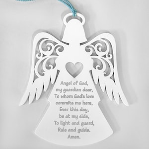 May include: White wooden angel ornament with a cutout design and a heart in the center. The ornament has a blue string for hanging and a poem inscribed on the front: "Angel of God, my guardian dear, To whom God's love commits me here, Ever this day, be at my side, To light and guard, Rule and guide. Amen."
