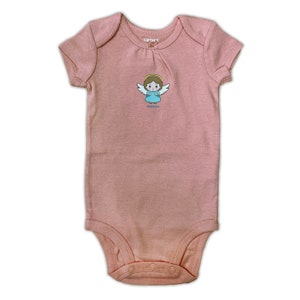 May include: A pink baby onesie with short sleeves and a snap closure. It features a cartoon angel with a halo and wings.