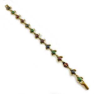 May include: A gold bracelet with a chain and colorful turtle charms. The turtles are striped with green, red, and blue enamel.