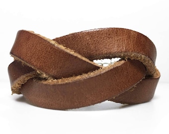 May include: A brown leather bracelet with a braided design.