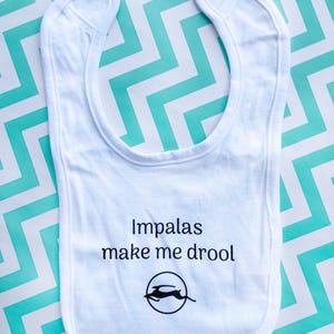 May include: White baby bib with the text "Impalas make me drool" and a black silhouette of an impala inside a circle.