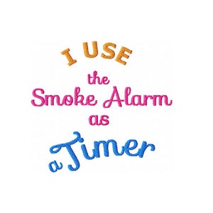 May include: A colorful embroidered design with the text "I use the smoke alarm as a timer". The text is in orange, pink, and blue.